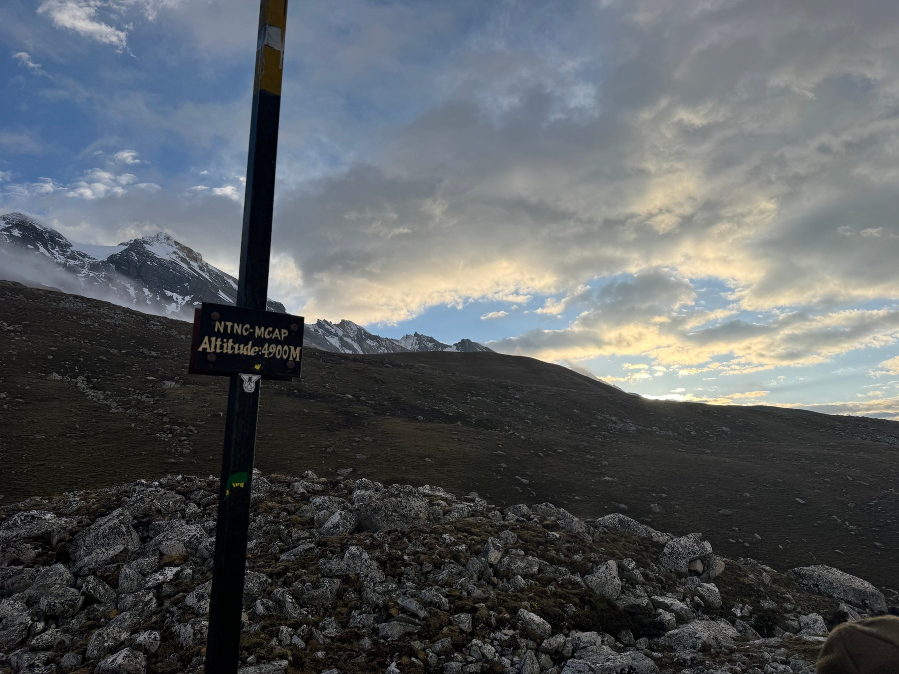A trail sign beneath the morning sky.